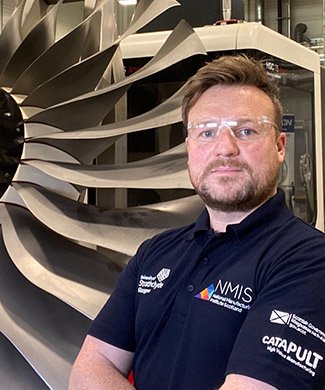 Man standing in front of an aeroplane engine NMIS