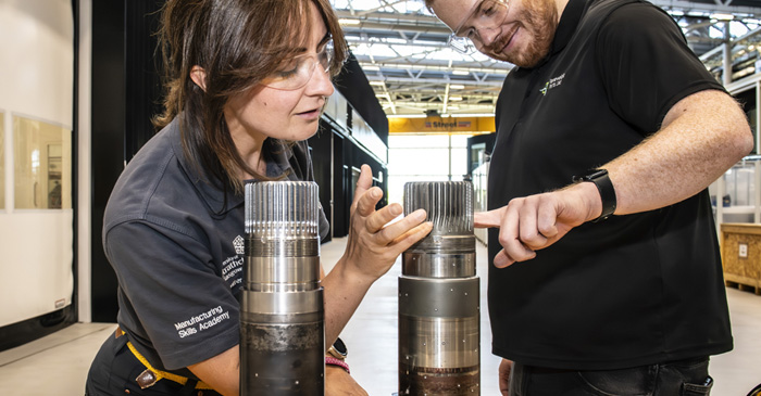 NMIS engineer and RPL engineer inspecting reconditioned pinion shaft