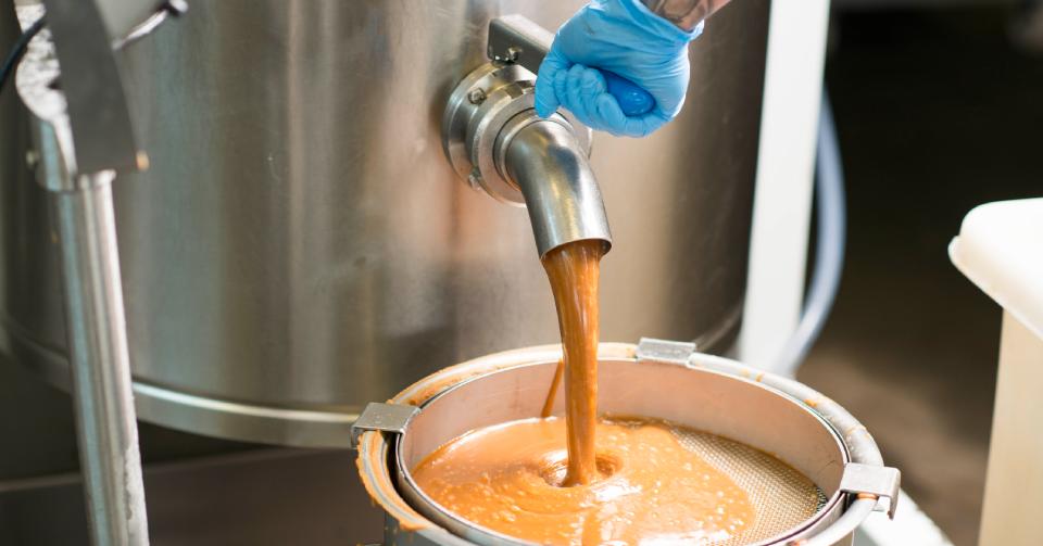 Fudge being produced coming out of a spout